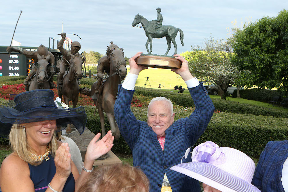 Robert Low receives a trophy for the first-place finish of his racehorse Magnum Moon at the Arkansas Derby.